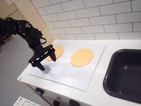NORA robot trial with a blue cube and a plate